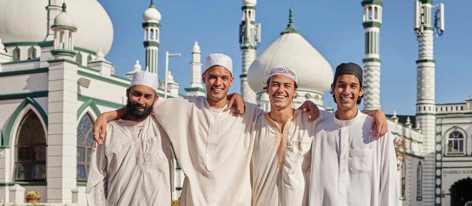 Smiling pilgrims in white at the mosque