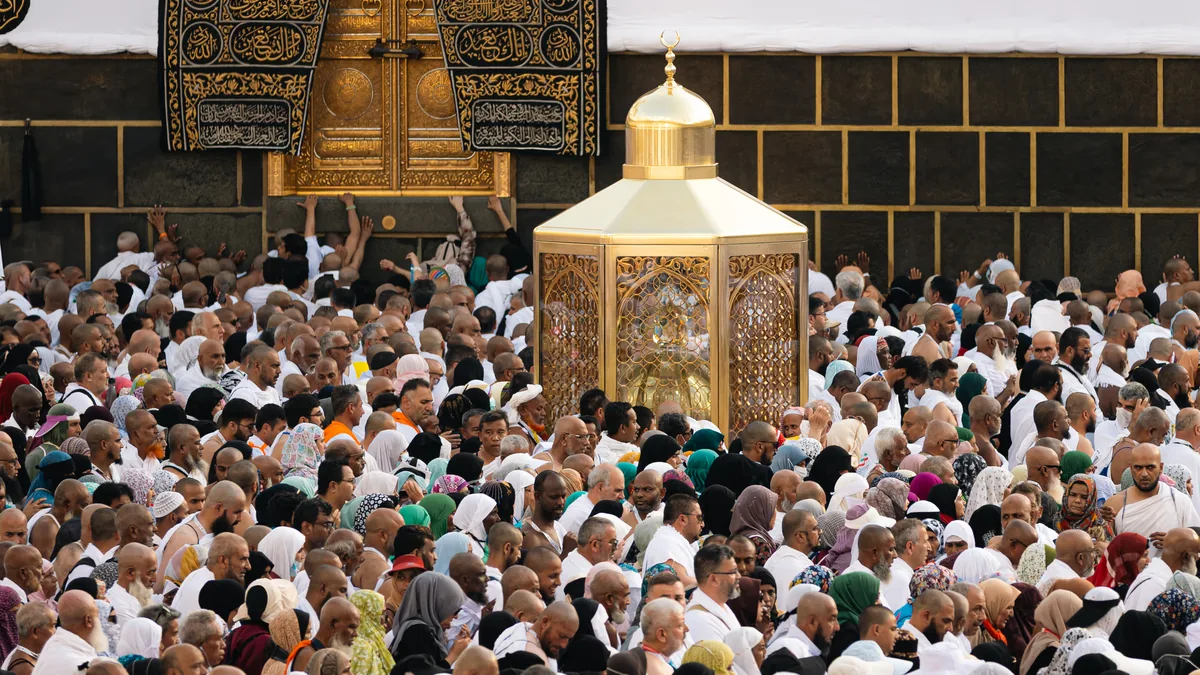 Pilgrims around Maqam Ibrahim beside the Kaaba