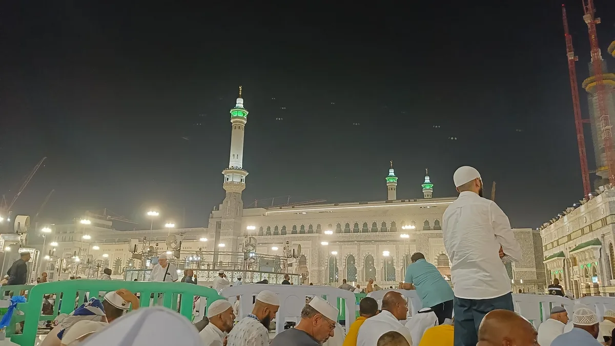 Pilgrims in the courtyard outside Masjid al-Haram at night