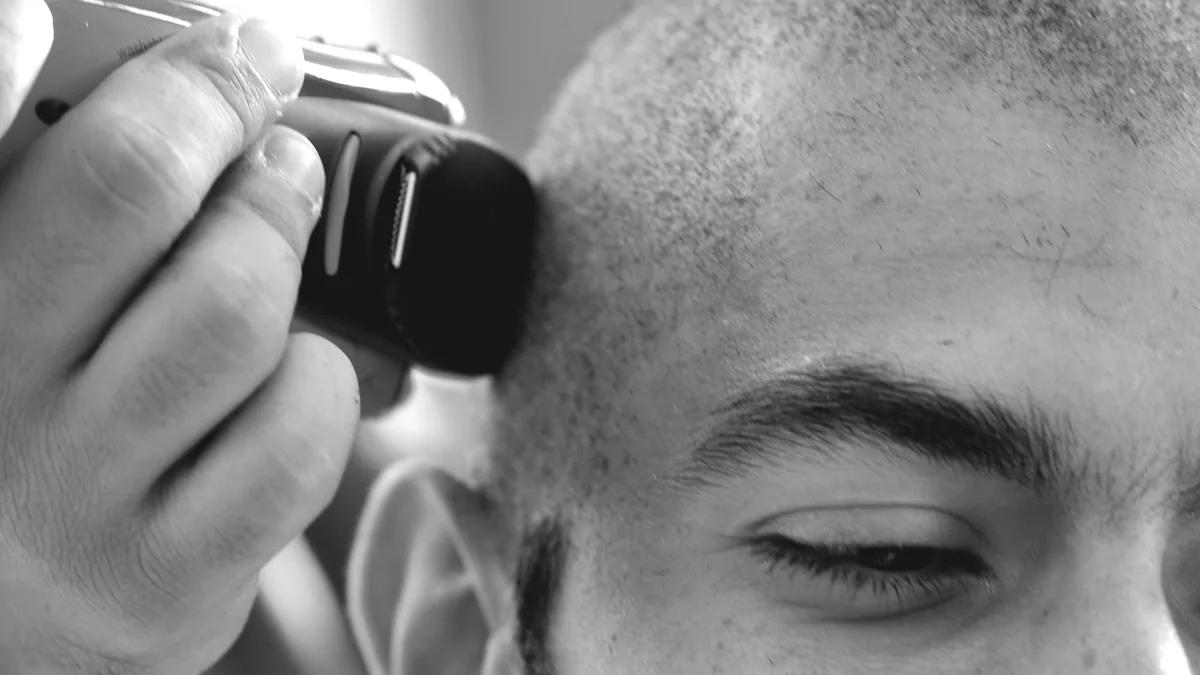 A pilgrim having hair trimmed after Hajj in an archive photograph